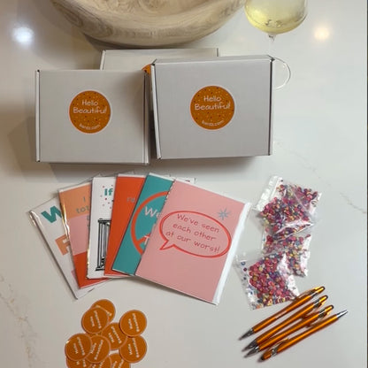 "Sassy friendship greeting card box set flat-lay unboxing featuring 6 funny 5x7 cards in cellophane sleeves, BARDZ gift boxes, Hello Beautiful stickers, and confetti."